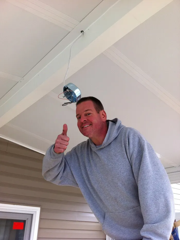 Current Power electrician giving a thumbs-up after installing a porch fan