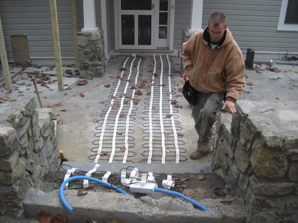 Snow-melt heating cables laid in a stone walkway before the pavers go down